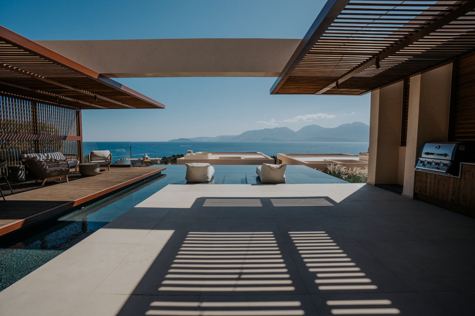 Outdoor kitchen, pergola and infinity pool overlooking the Gulf of Mirabello