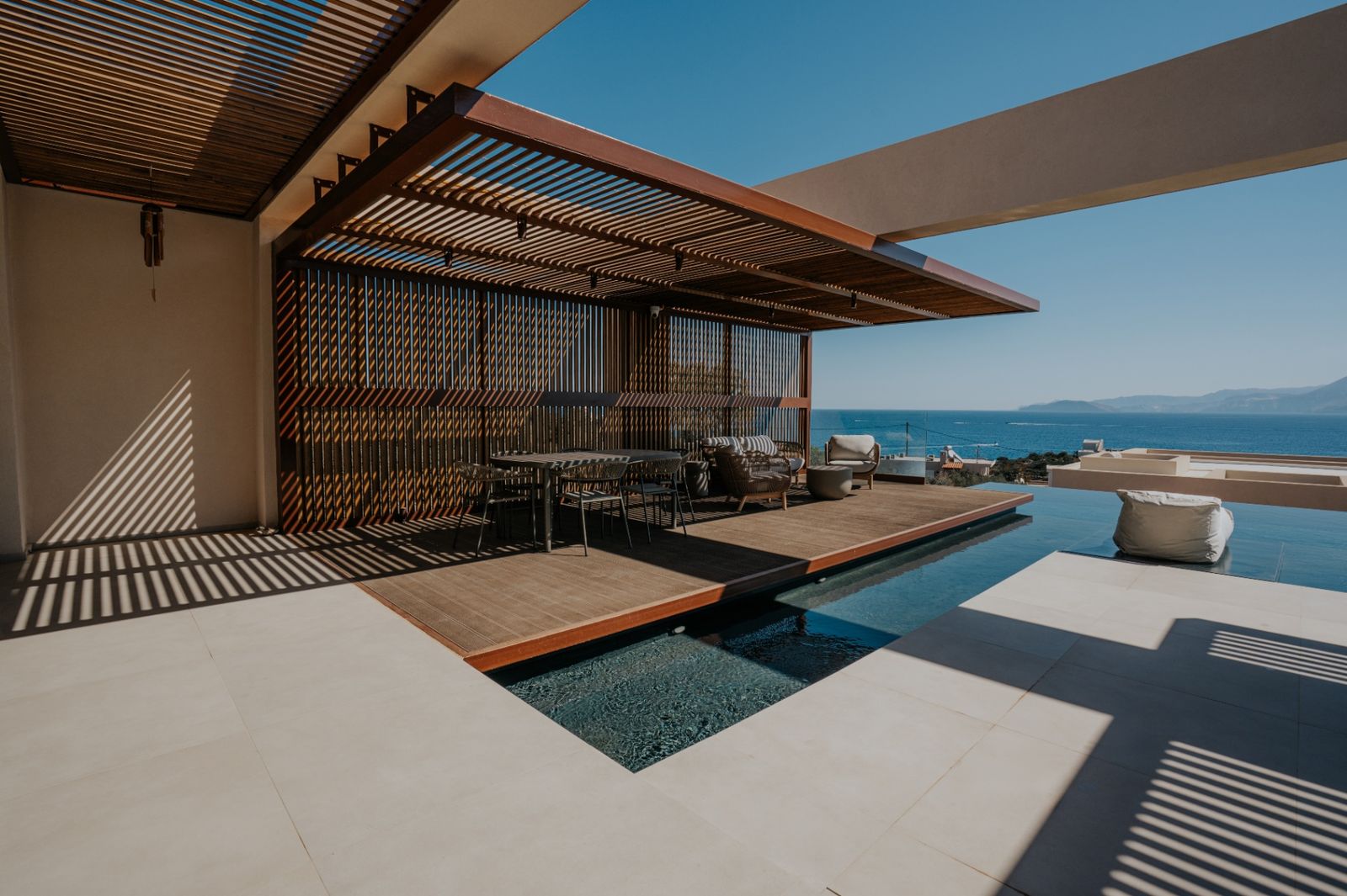 Timber pergola and terrace with pool and sea view