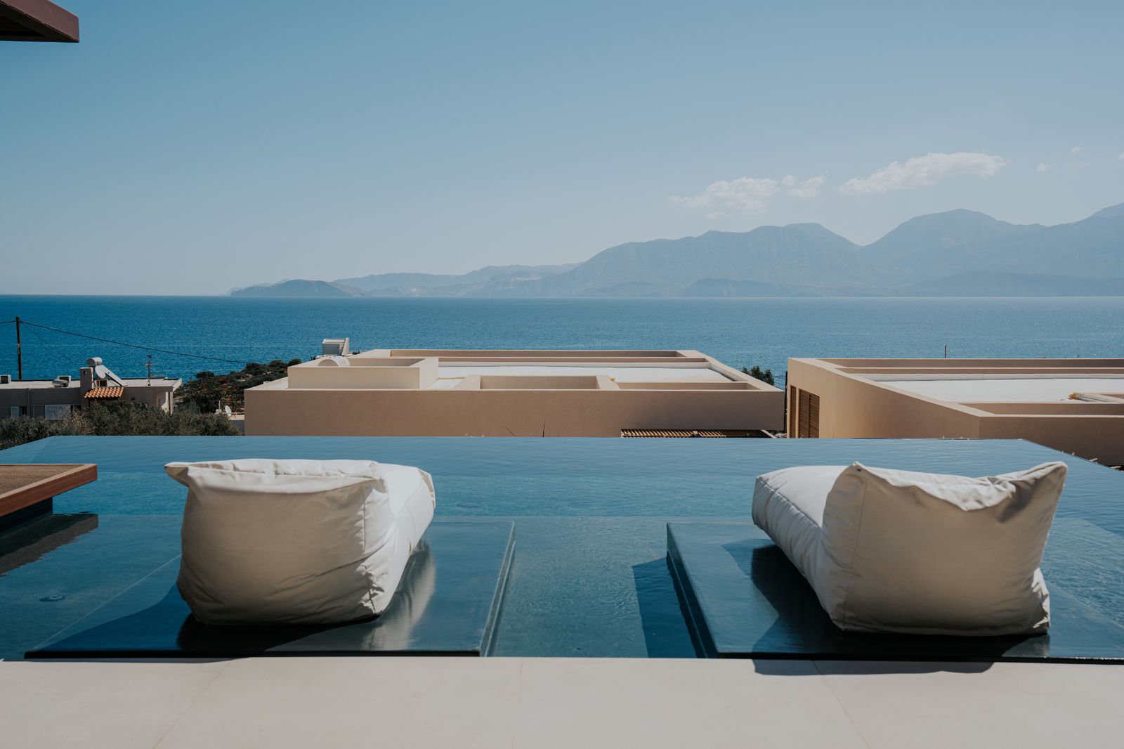 Infinity pool with view across the Aegean toward the mountains